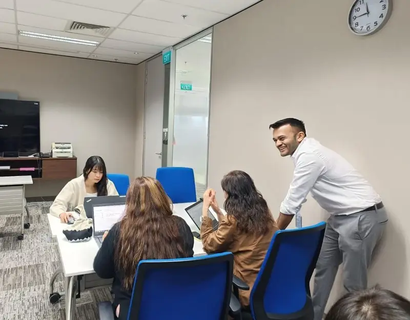Daksh at a workshop table, the human in the loop.